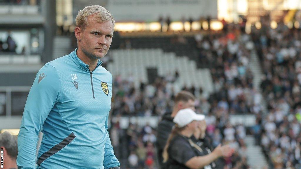 Oxford United boss Liam Manning on the touchline for the U's during a League One game.