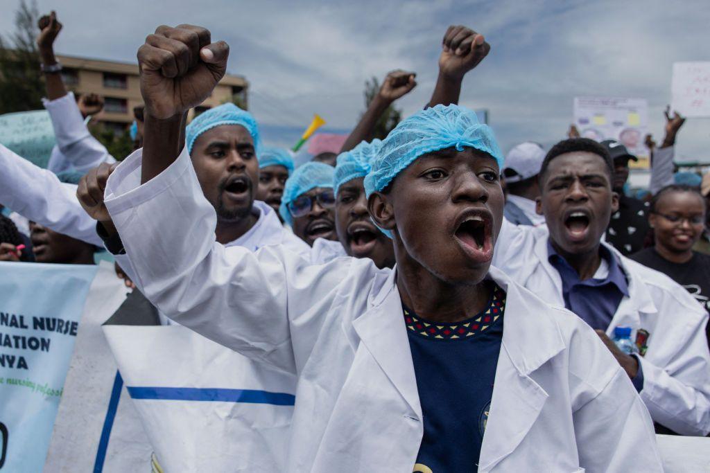 Kenyan doctors chant outside the health ministry headquarters protesting with placards to demand better pay and working conditions in the capital, Nairobi on April 9, 2024. 