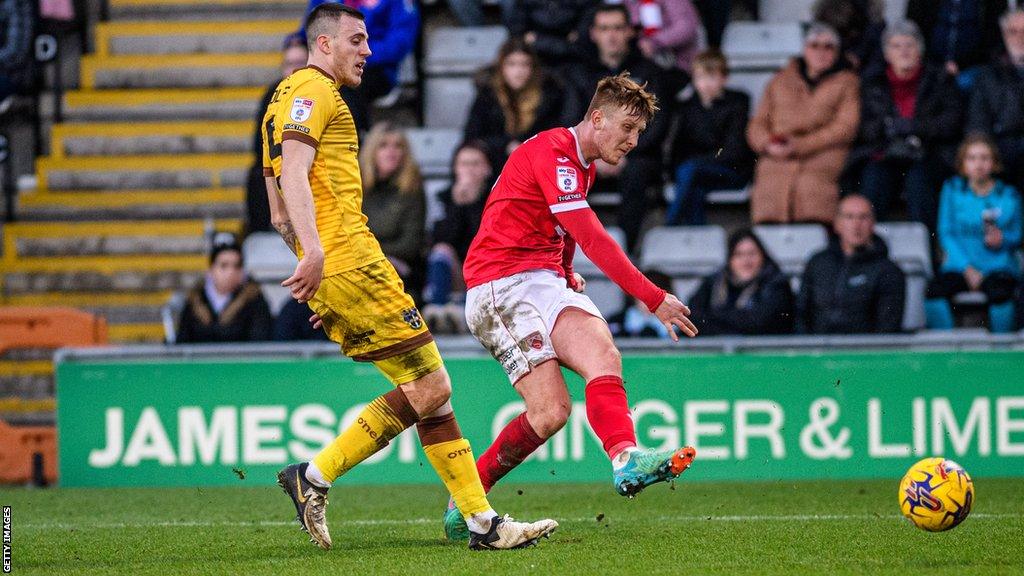 Gerard Garner of Morecambe is attempting a shot on goal during the League Two match between Morecambe and Sutton United