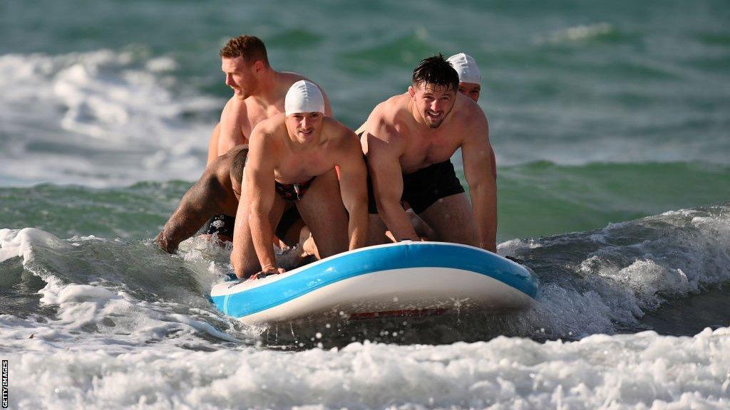 England's players paddleboarding