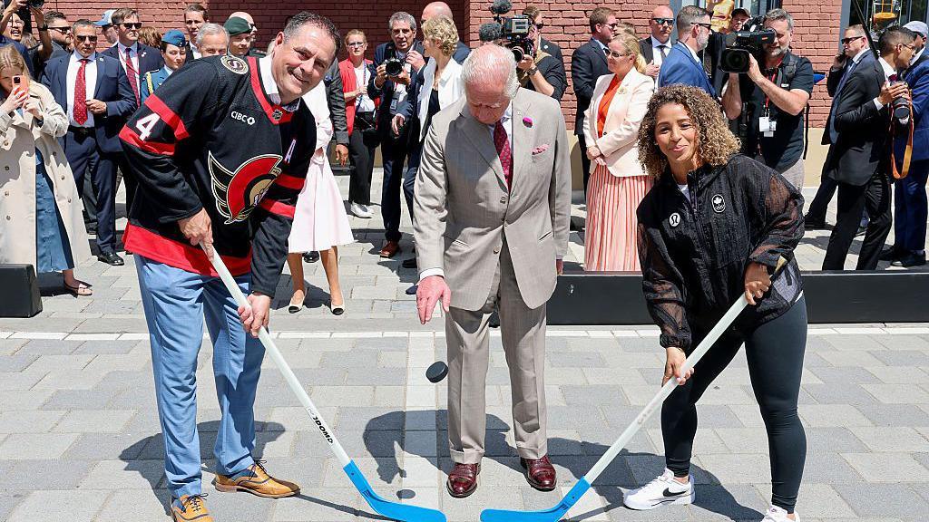  King Charles III drops the puck to launch the hockey match at a community event in Lansdowne Park during an official visit to Canada on May 26, 2025 in Ottawa, Ontario. 