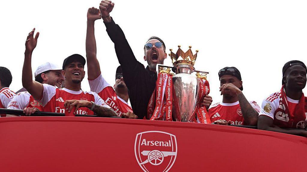 Josh Kroenke, co-chairman of Arsenal, was shown enjoying the celebrations on the bus, with Piero Hincapie, William Saliba, Gabriel and Bukayo Saka next to him