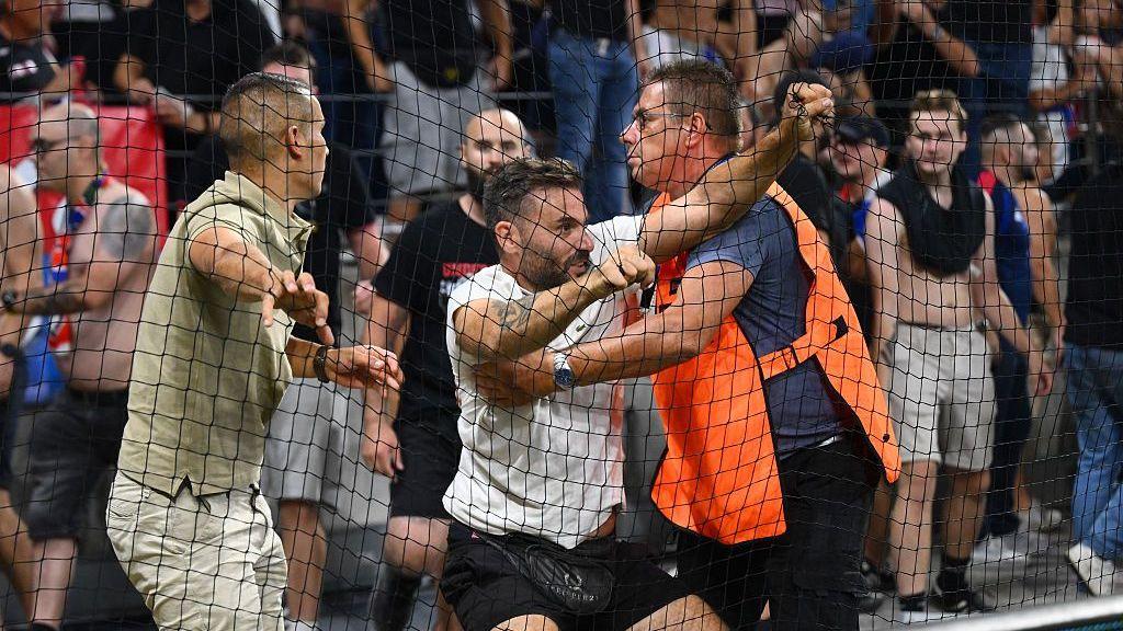 Football fans are held back by stewards