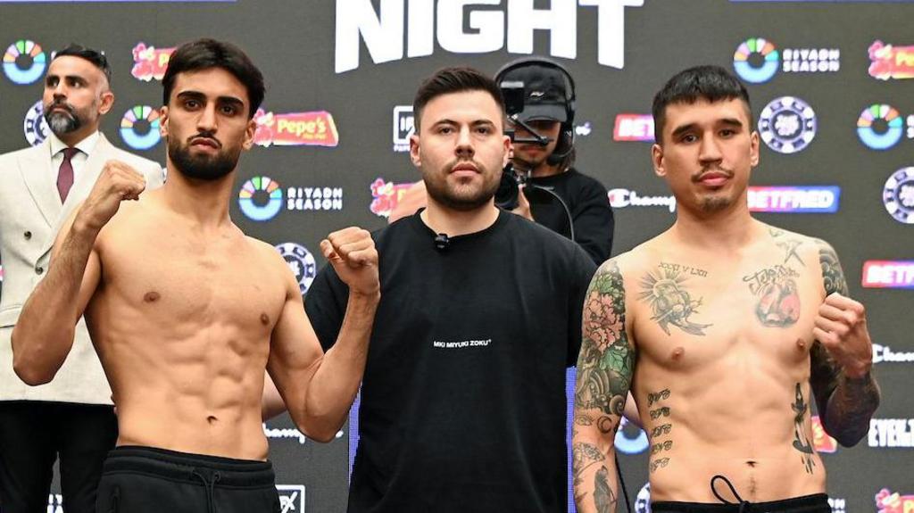 Adam Azim and Steve Claggett hold up their fists