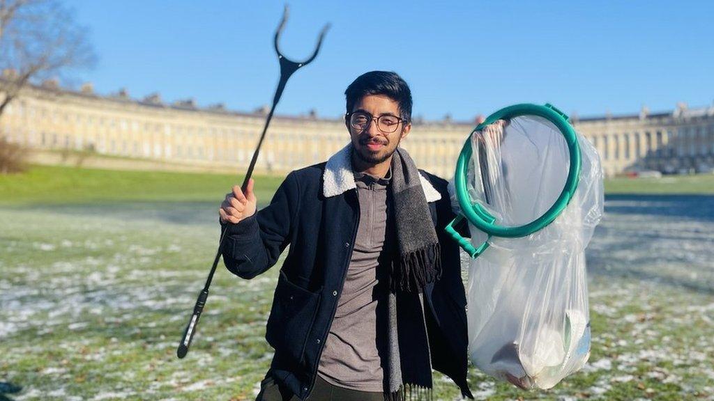 Vivek Gurav holding a litter grabber and bin bag