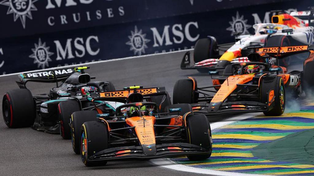 Behind leader Lando Norris, McLaren's Oscar Piastri and Mercedes' Kimi Antonelli collide going into the first corner during the Sao Paulo Grand Prix
