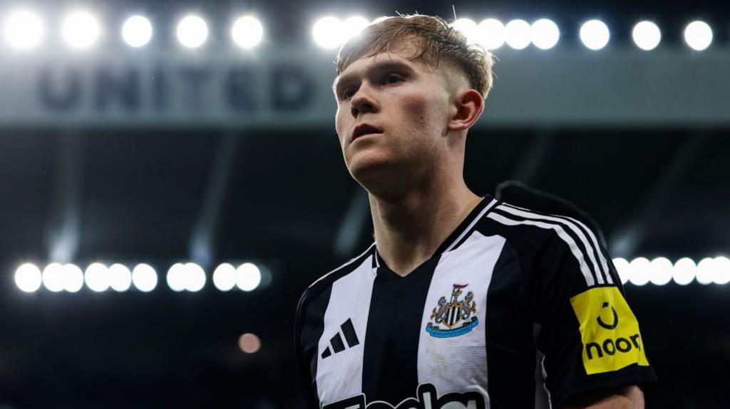 Lewis Hall looks on under St James' Park lights