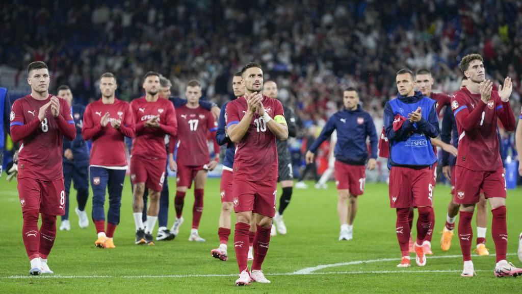 Serbia applaud supporters 