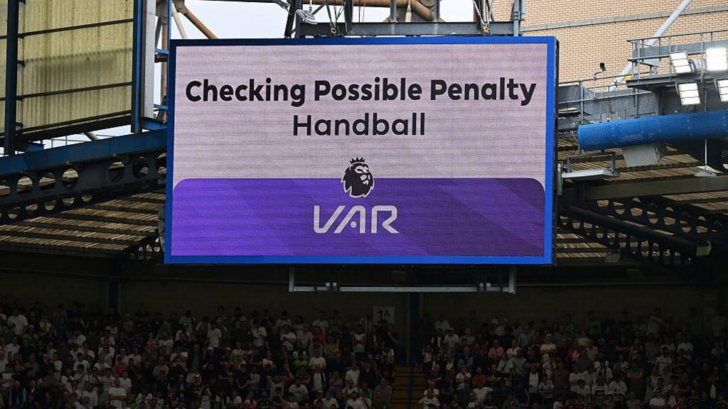 A big screen at Stamford Bridge tells the crowd that VAR is checking for a penalty during this season's game between Chelsea and Brentford