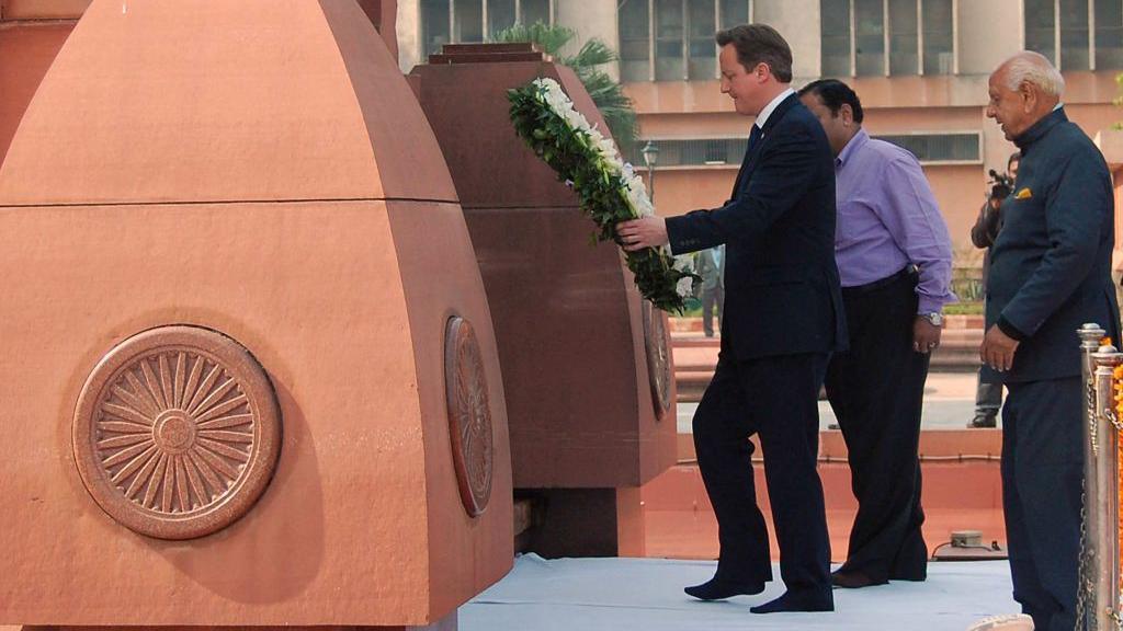 British Prime Minister David Cameron lays a wreath in tribute to the Jallianwala Bagh martyrs at the Jallianwala Bagh memorial in Amritsar on February 20, 2013. British Prime Minister David Cameron visited the site of a colonial-era massacre in India on Wednesday, describing the episode as "deeply shameful" while stopping short of a public apology.
