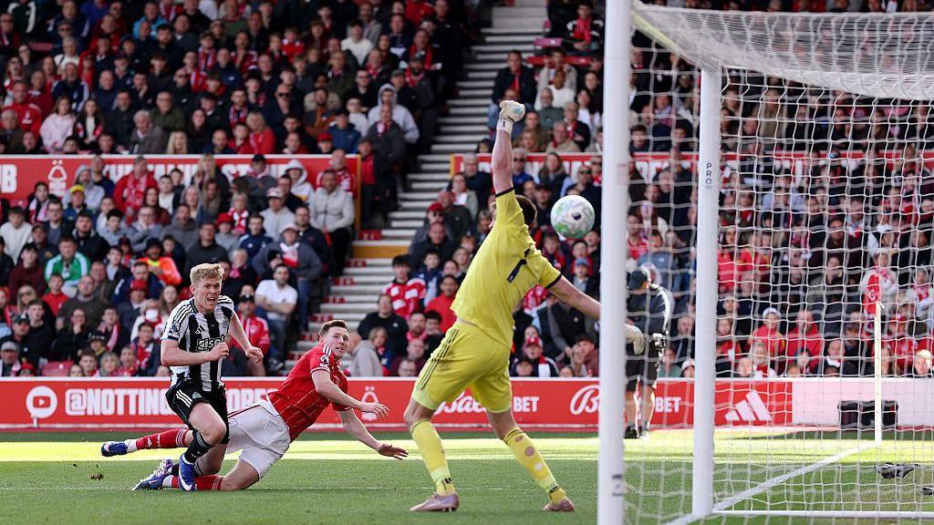 Lewis Hall unsuccessfully attempting to stop Elliot Anderson scoring for Nottingham Forest against Newcastle