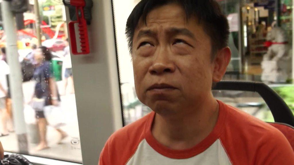 Man sniffing scented bus in Singapore