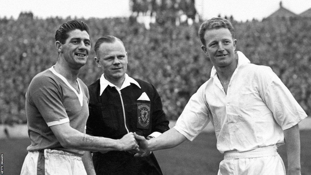 Cardiff City's Trevor Ford shakes hands with Wales team-mate Ivor Allchurch of Swansea Town in front of referee Mervyn 'Sandy' Griffiths in 1956