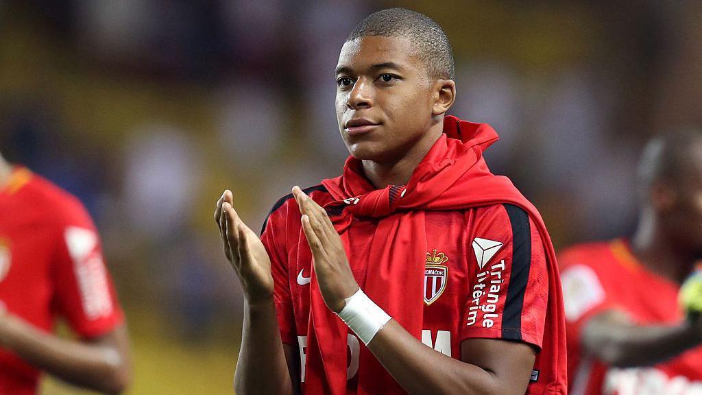 Kylian Mbappe applauds fans during his time at Monaco