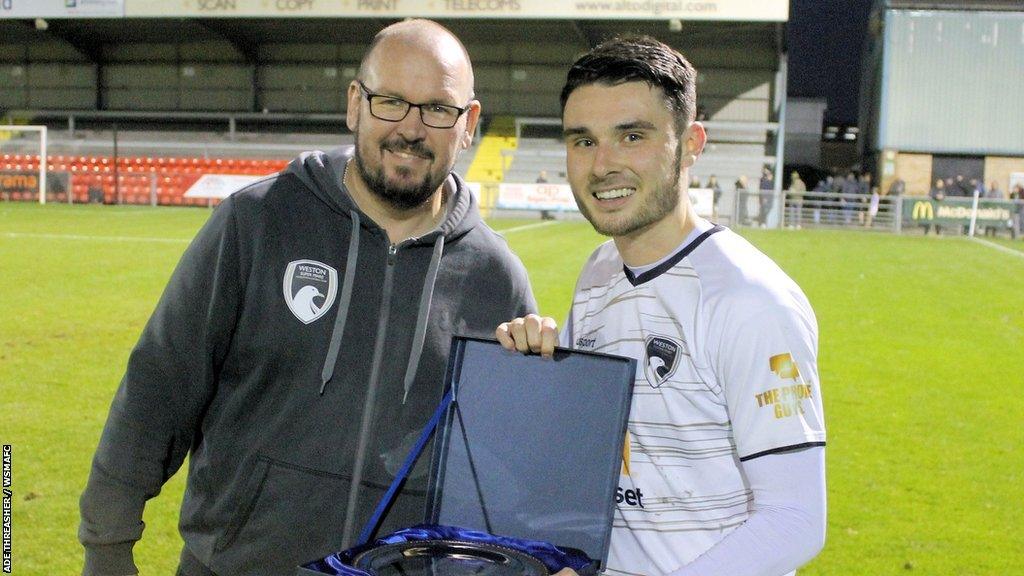 Alex Fletcher (right) receiving his award for man of the match for Weston-super-Mare AFC