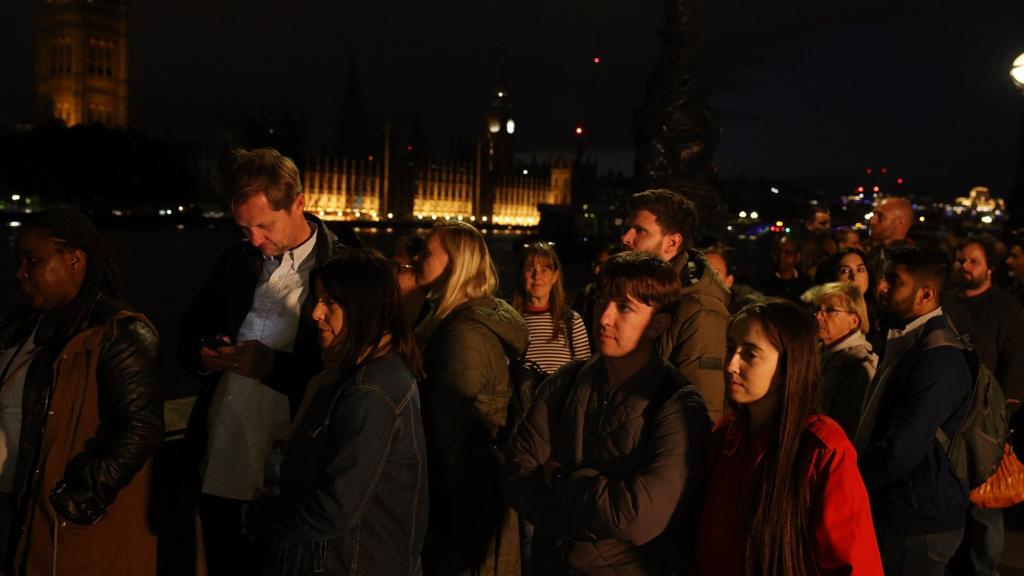 People in the queue during the minute's silence