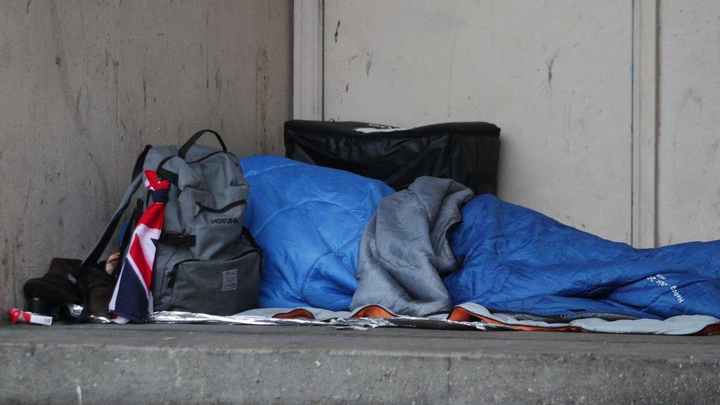 A person sleeping in a doorway