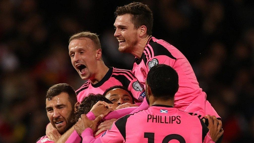 Scotland players celebrate their late goal in victory against Slovakia