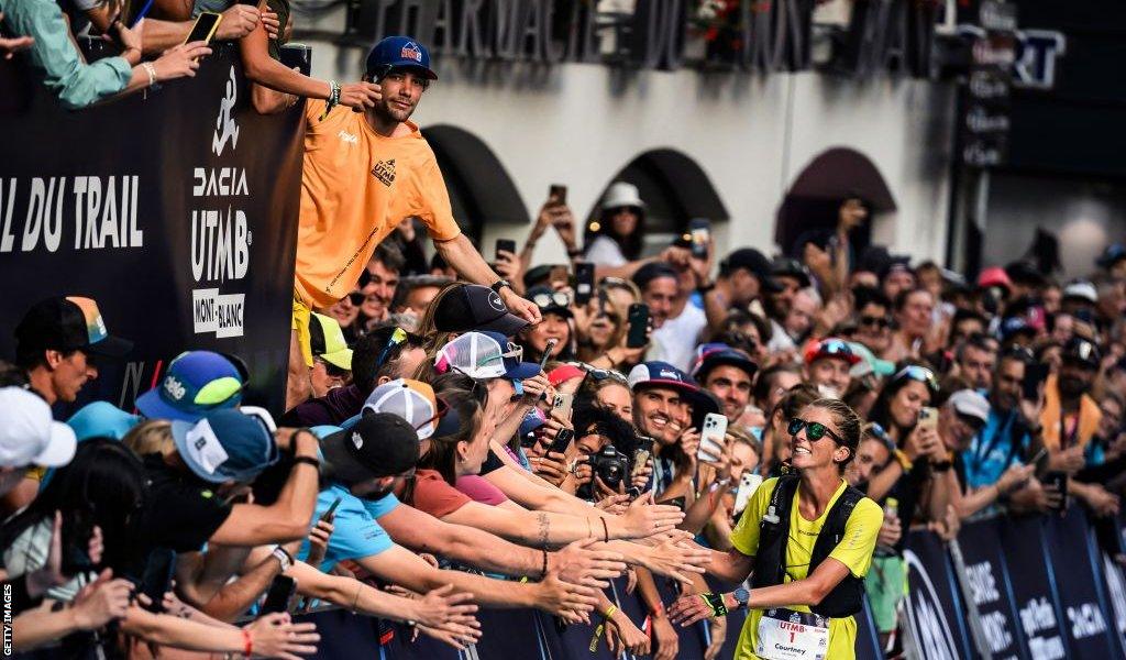 Courtney Dauwalter greets fans close to the UTMB finishline