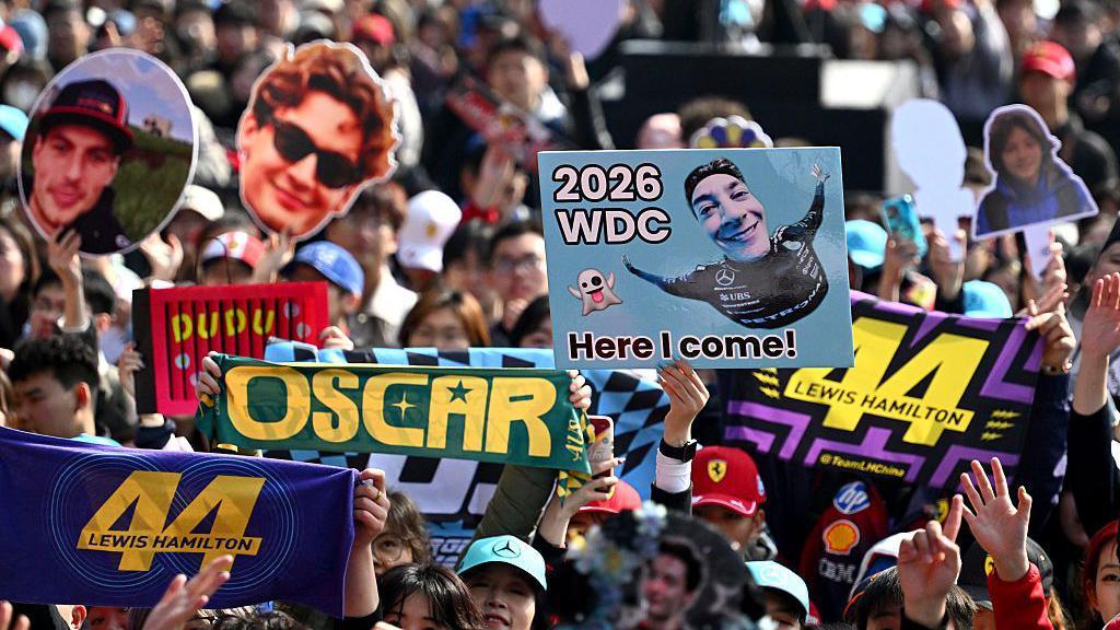 Fans hold up signs during first practice in Shanghai 