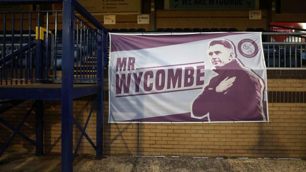 A banner of Matt Bloomfield displaying the message 'Mr Wycombe' at Adams Park