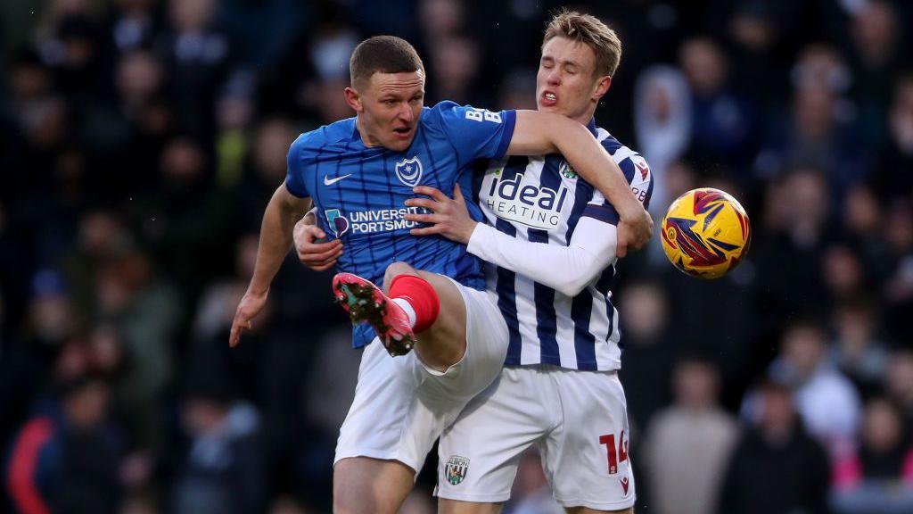 Portsmouth's Colby Bishop battles with West Brom's Torbjorn Heggem 