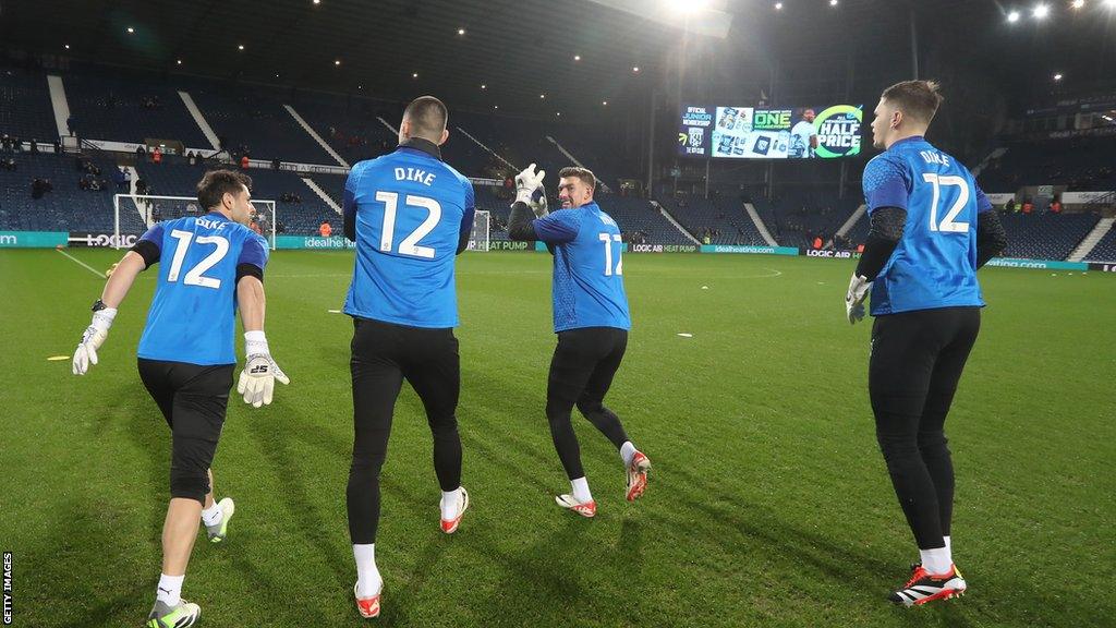 West Bromwich Albion players warm up wearing shirts with Dike 12 on the back showing support for an injured team mate Daryl Dike