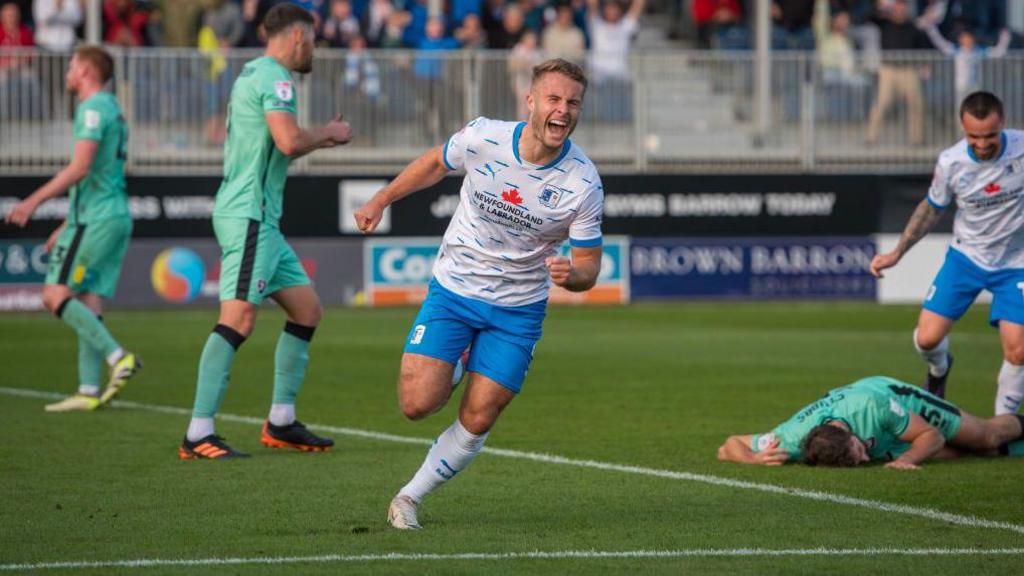 Barrow's Andrew Dallas celebrating scoring a goal