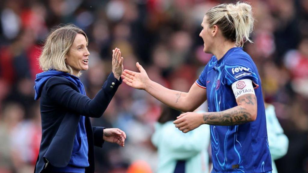 Sonia Bompastor and Millie Bright high-fiving