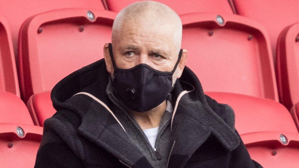 Warren Gatland wears a mask as he watches some Lions contenders