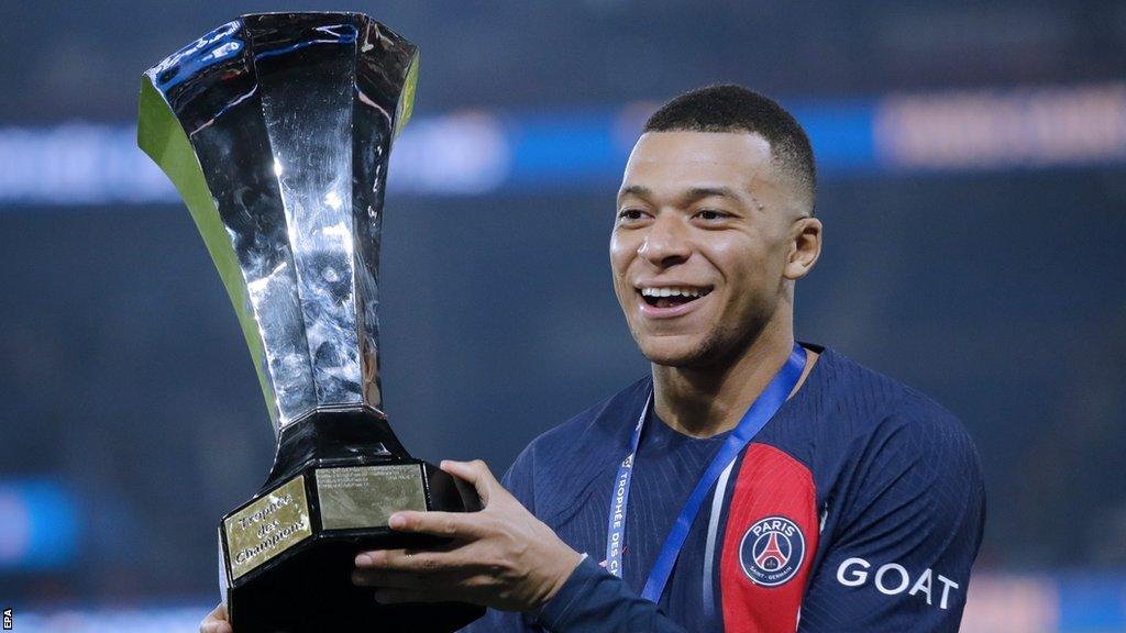 Paris St-Germain forward Kylian Mbappe holds the French Champions Trophy