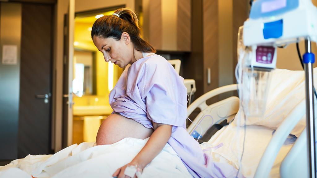 Pregnant woman in a hospital bed