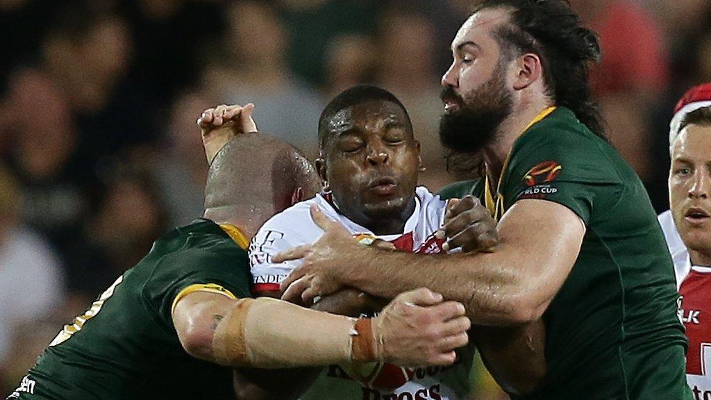 Jermaine McGillvary in action for England against Australia, being tackled by big front rowers David Klemmer and Aaron Woods