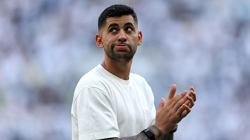 Cristian Romero of Tottenham Hotspur applauds the fans