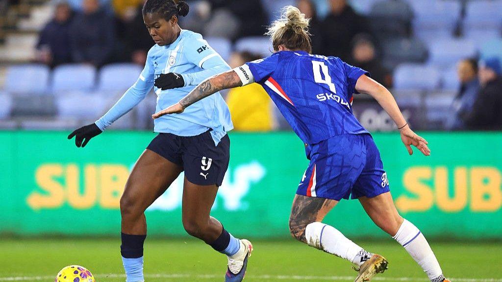 Khadija Shaw is challenged by Millie Bright