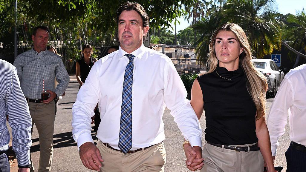 Matt Wright (L), the star of Netflix show Wild Croc Territory and National Geographic's Outback Wrangler, arrives with his wife Kaia Wright (R) at the Supreme Court in Darwin
