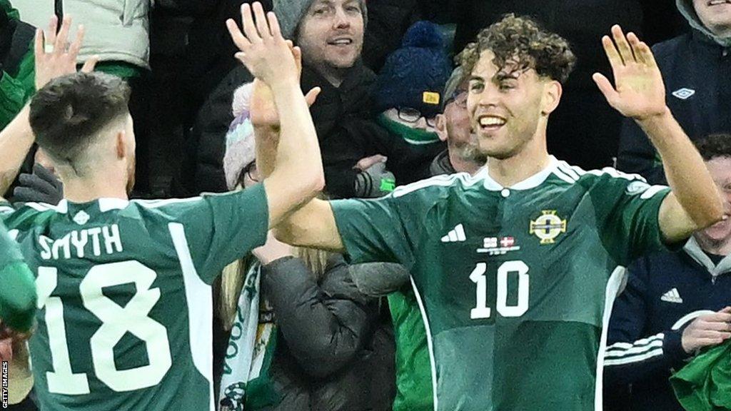 Dion Charles (right) in congratulated by team-mate Paul Smyth after netting Northern Ireland's second goal in the 2-0 win over Denmark