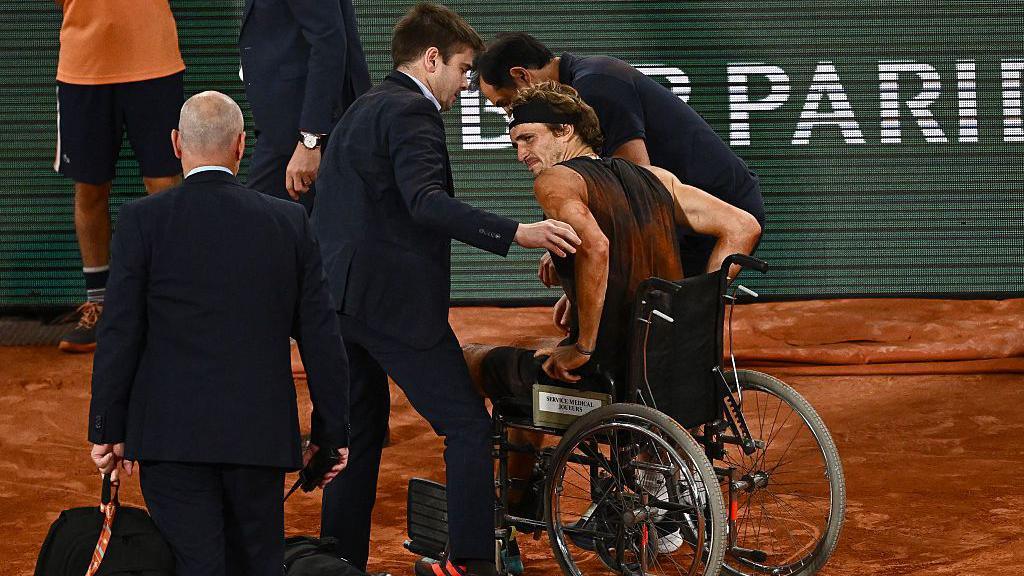 Alexander Zverev leaves Court Philippe-Chatrier in a wheelchair