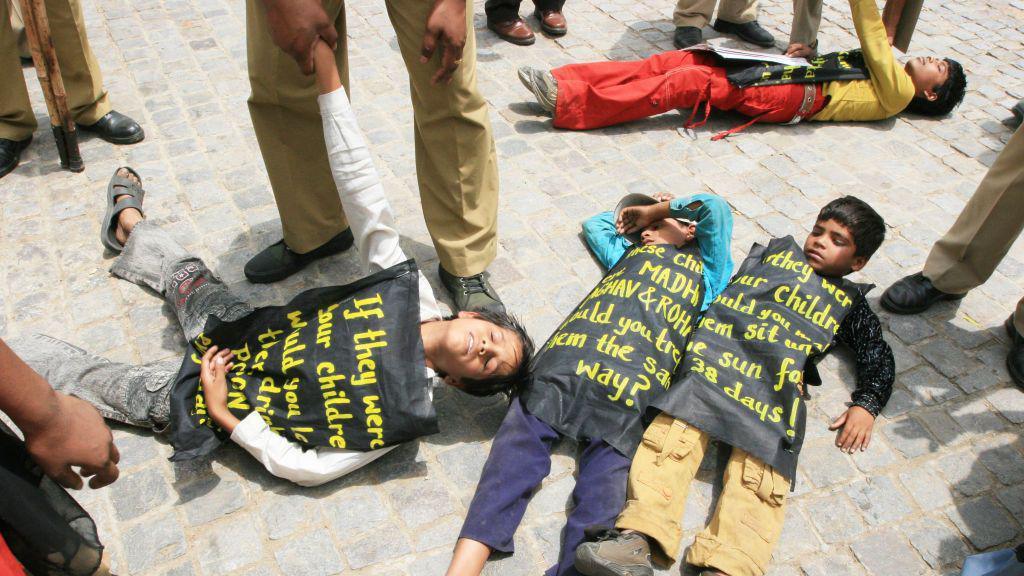 NEW DELHI, INDIA - MAY 5, 2008: Policemen arrest Bhopal gas tragedy victims from outside Indian Prime Minister's house, on May 5, 2008 in New Delhi, India. More than 40 children of Bhopal gas tragedy victim along with their parents demonstrated outside prime minister house demanding economic and medical rehabilitation, environmental clean-up and provision of clean drinking water. Bhopal Gas leak disaster killed at least 10,000 people and affected some 550,000 others in the central Indian city of Bhopal in December 1984. (Photo by Sonu Mehta/Hindustan Times via Getty Images)