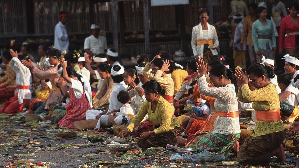 Balinese women praying during a religious ceremony.