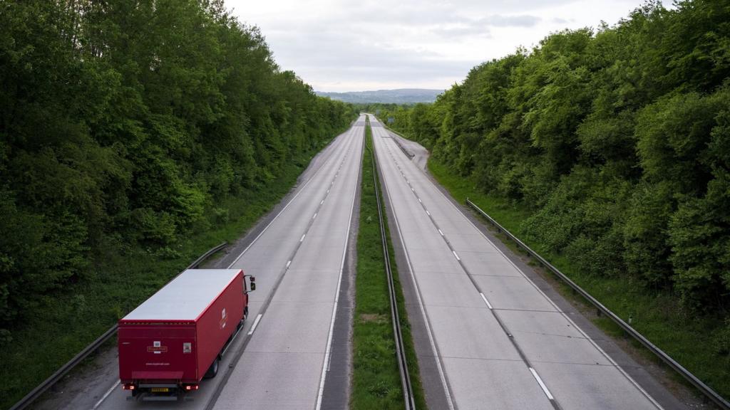 A lorry driving along a deserted road