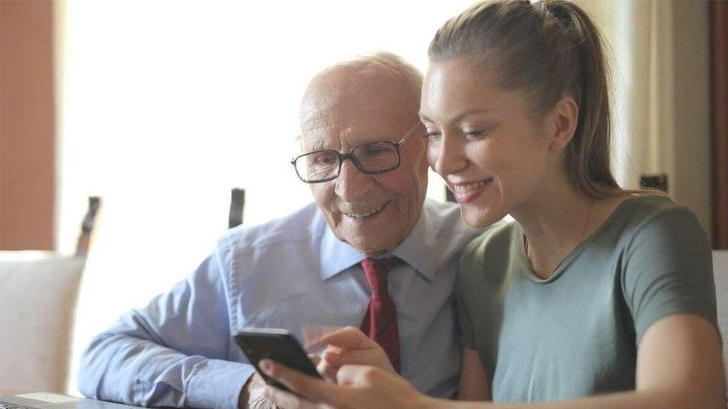 Woman and man looking on phone