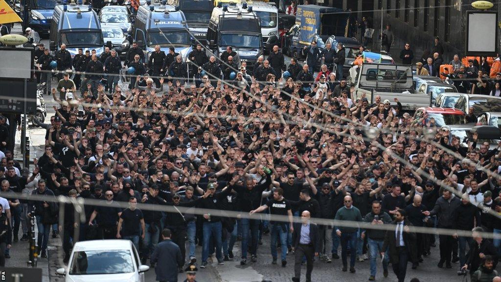 Fans march through streets