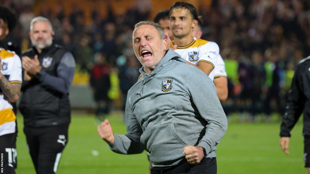 Port Vale manager Andy Crosby celebrates after his side win on penalties in the Carabao Cup