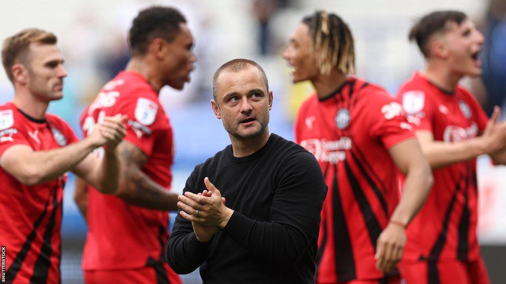 Manager Shaun Maloney celebrating after Wigan win at Bolton in EFL League One football