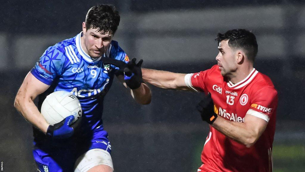 Monaghan's Darren Hughes is challenged Red Hands forward Darren McCurry in Omagh