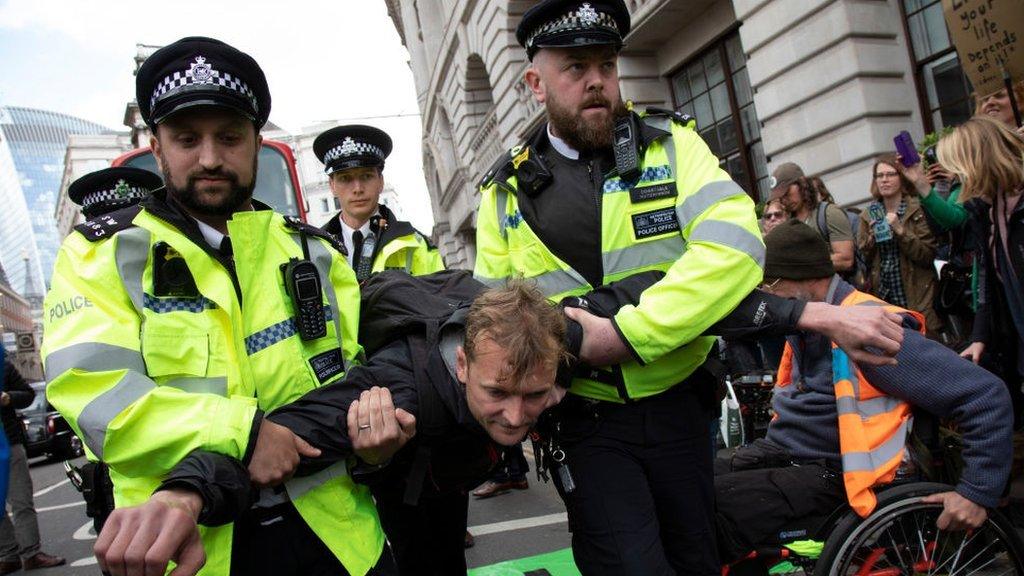 protester being removed from the street at Bank