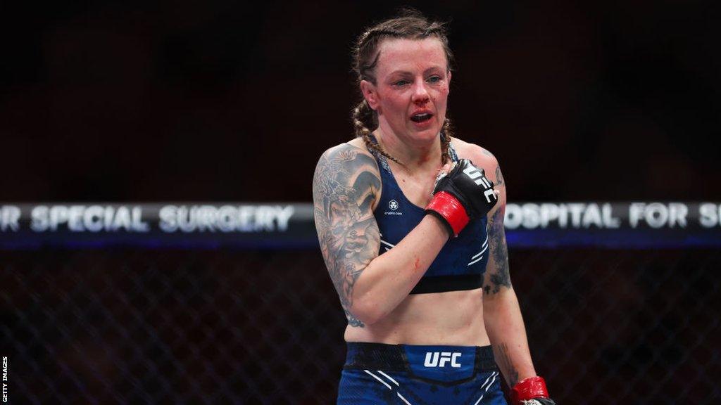 Joanne Wood celebrates after beating Maryna Moroz at UFC 299.