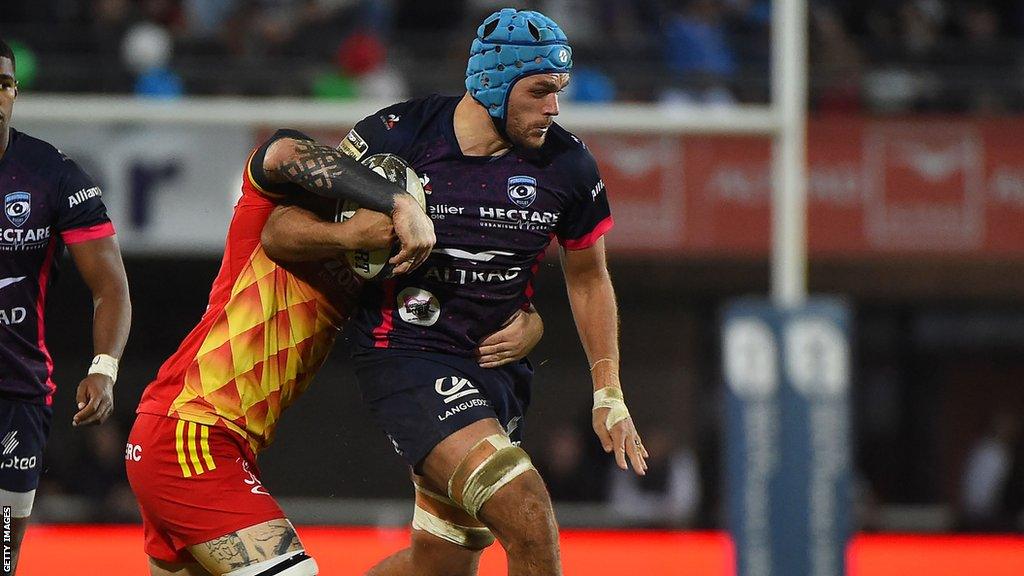 Zach Mercer is tackled with the ball during a game for Montpellier