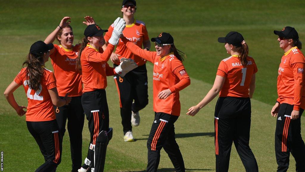 Blaze players celebrate taking a wicket